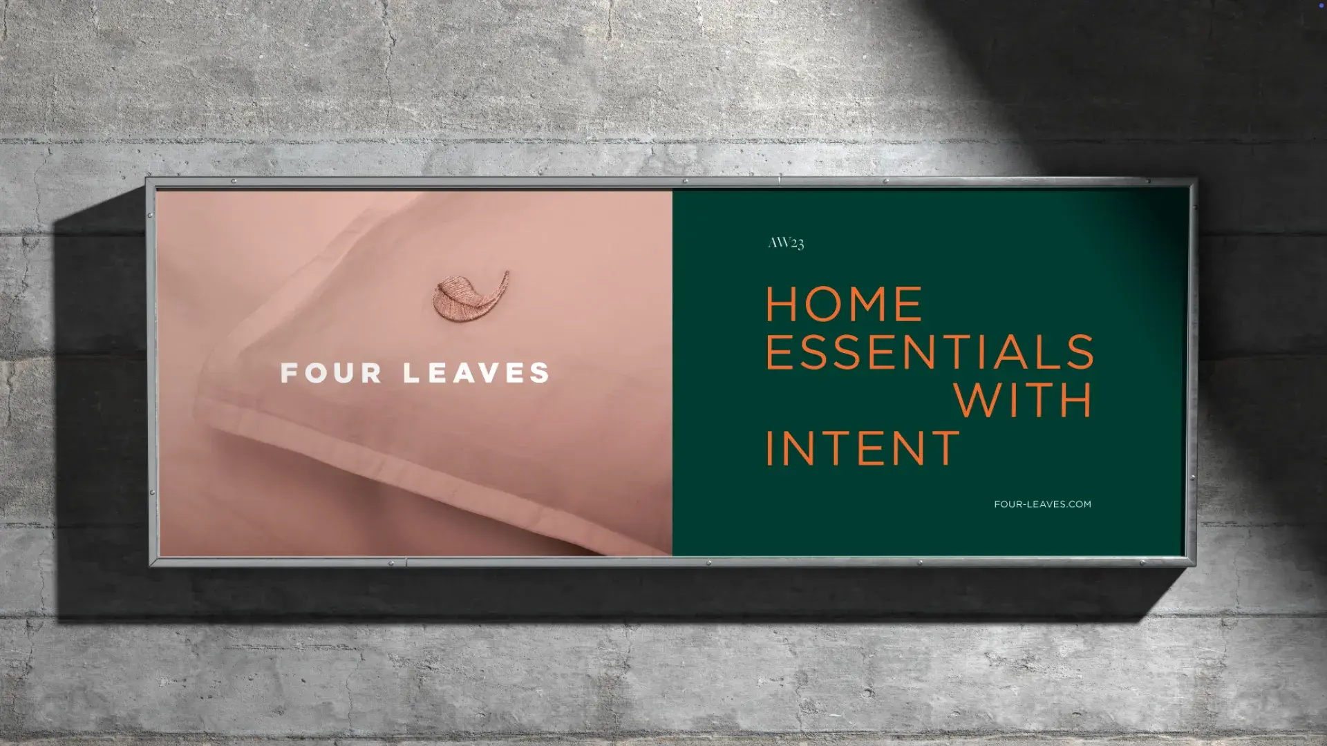 A billboard with "Four Leaves" on a pink pillow image and "Home Essentials with Intent" on a green background.