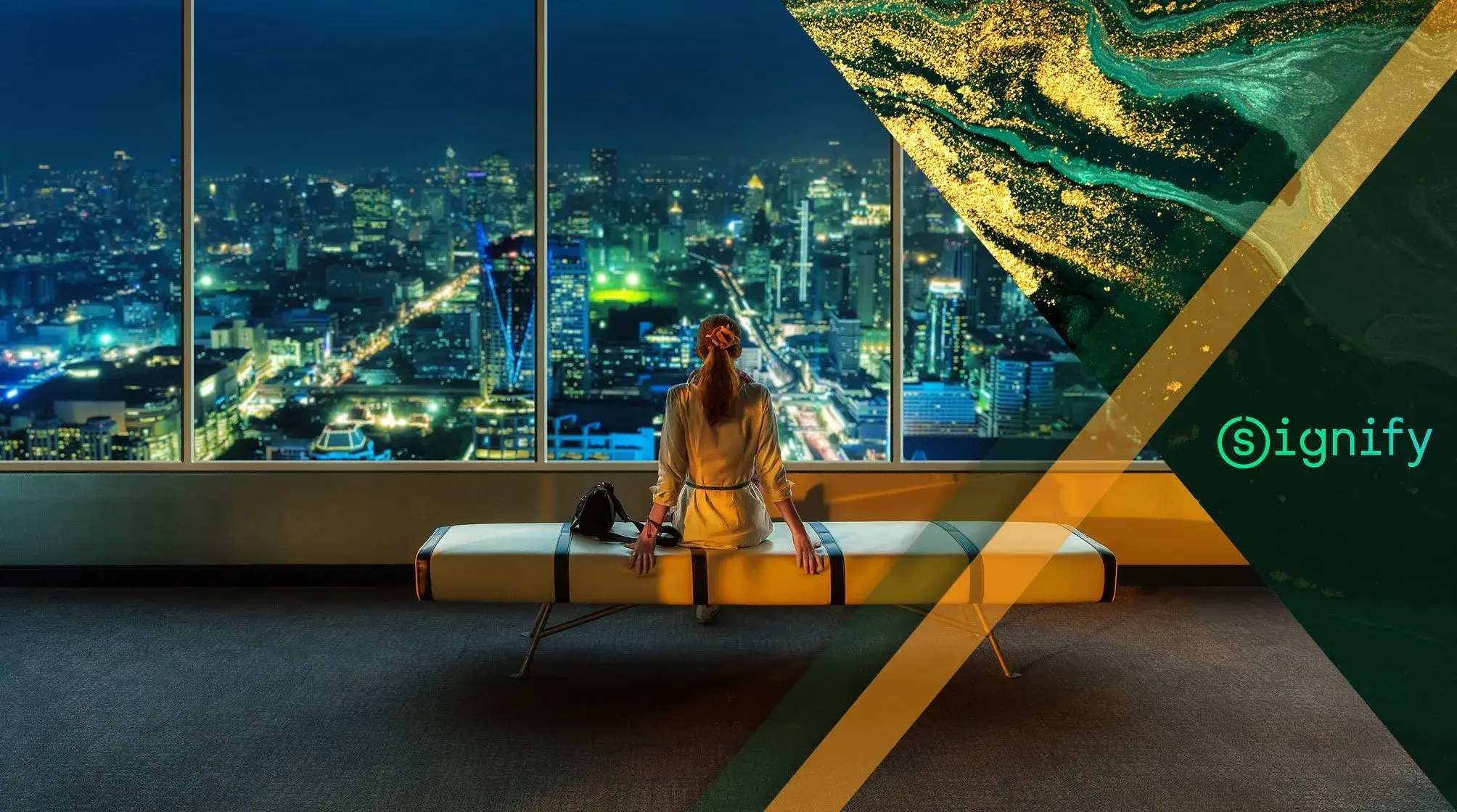 Woman sitting on a bench, gazing at a cityscape through large windows at night, with "Signify" logo and abstract design overlay.
